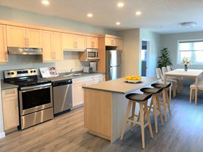 Portage La Prairie apartment for rent - a kitchen with a center island and a table with chairs