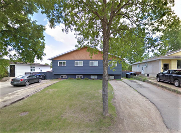 Brandon apartment for rent - a blue house with a tree in front of it