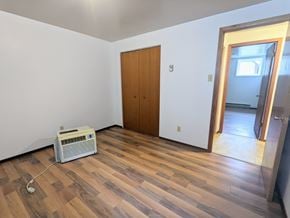 Brandon apartment for rent - an empty living room with wood flooring and a heater