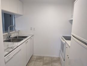 Brandon apartment for rent - an empty kitchen with white appliances and a sink