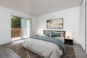 Watsonville apartment for rent - a bedroom with a bed and a sliding glass door