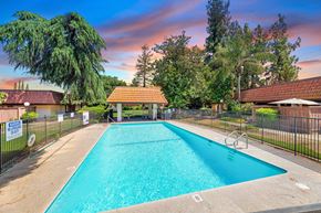 Clovis apartment for rent - a swimming pool with a fence and a house with a pool