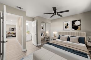 Moreno Valley apartment for rent - A bedroom with a large bed and a ceiling fan.