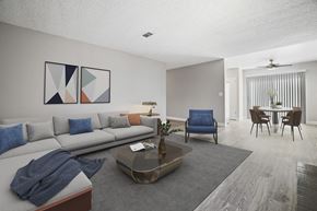 Fresno apartment for rent - A living room with a grey sofa, a blue chair, and a coffee table.