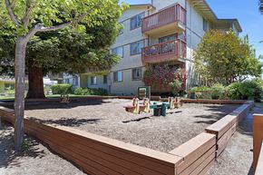 Watsonville apartment for rent - an outdoor play area in front of an apartment building