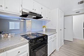 Madera apartment for rent - the preserve at ballantyne commons apartment kitchen with stainless steel appliances and white cabinets