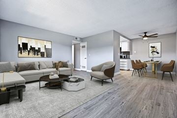 Clovis apartment for rent - A living room with a grey couch, a coffee table, and a painting on the wall.