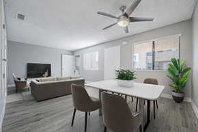 Indio apartment for rent - A living room with a white table and brown chairs.