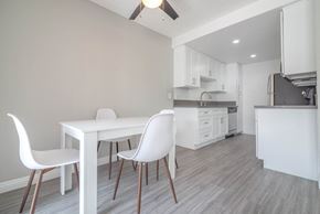 Palm Springs apartment for rent - a dining room and kitchen with a white table and chairs