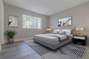 Lake Elsinore apartment for rent - a bedroom with a bed and a rug and a window