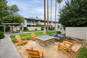 Palm Springs apartment for rent - A backyard with a fire pit and chairs.
