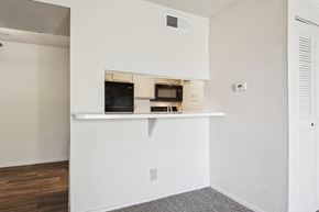 Waco apartment for rent - A white kitchen with a microwave and oven built into the cabinetry.