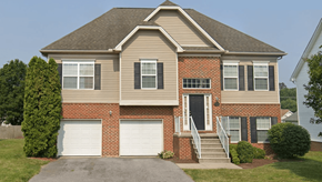 Martinsburg apartment for rent - a house with two garage doors and a stair case in front of it