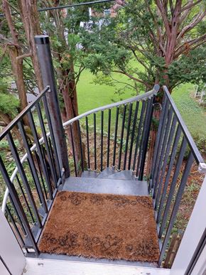 Frederick apartment for rent - A metal staircase with a brown doormat on the bottom step.