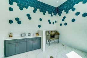 Vero Beach apartment for rent - a kitchen with blue cabinets and tile walls and a grill