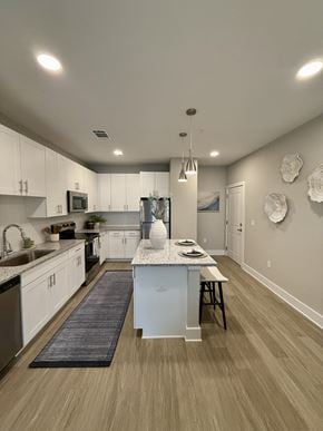 St. Augustine apartment for rent - A modern kitchen with white cabinets and a center island.