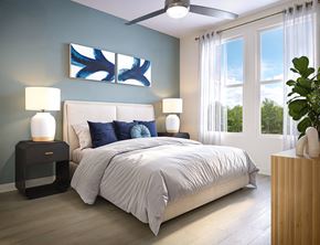 Daytona Beach apartment for rent - A bedroom with a bed, two lamps, and a painting on the wall.