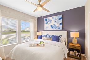 Vero Beach apartment for rent - a bedroom with a large bed and a ceiling fan