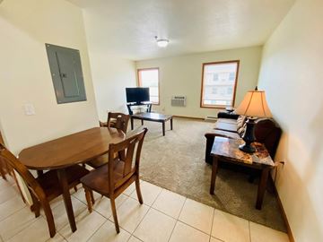 Williston apartment for rent - A living room with a brown table and chairs.