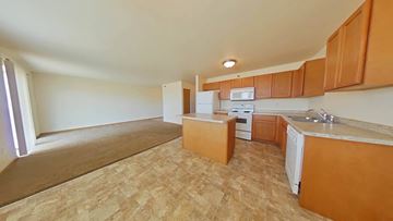 Tioga apartment for rent - A kitchen with wooden cabinets and a countertop.