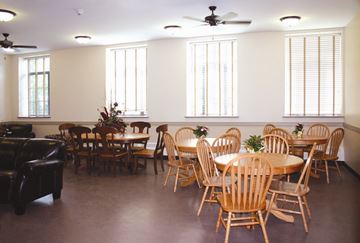 Ware apartment for rent - a dining room with tables and chairs and windows