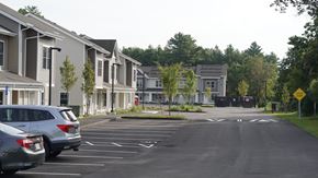 Ludlow apartment for rent - A parking lot in front of a residential area with cars parked.