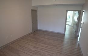 Holyoke apartment for rent - an empty living room with wooden floors and white walls