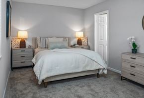 Wheeling apartment for rent - a bedroom with a bed and two night stands and a closet