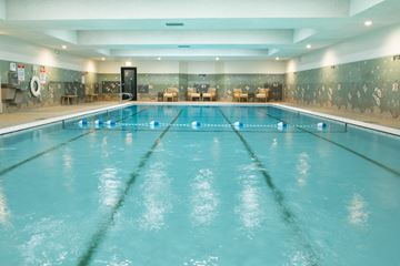 Chicago apartment for rent - A large indoor swimming pool with a blue tinted water.