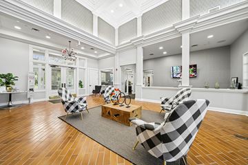 West Dundee apartment for rent - A living room with a checkered chair and a wooden coffee table.