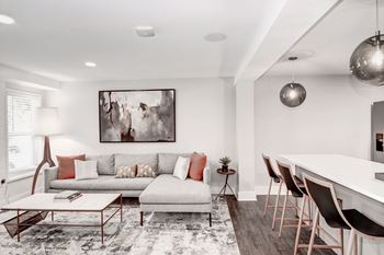 A living room with white walls and hardwood floors