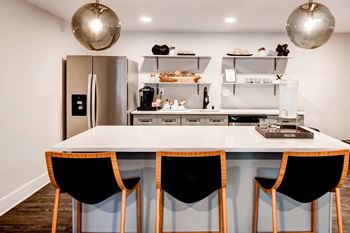 A kitchen with a large center island with a white countertop