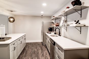 A kitchen with white countertops and stainless steel appliances