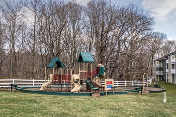 A playground with a swing set and slides