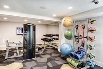 A home gym with a punching bag and weights