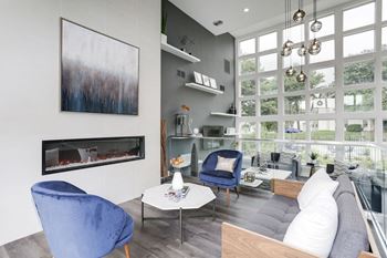 A living room with a large window and a fireplace