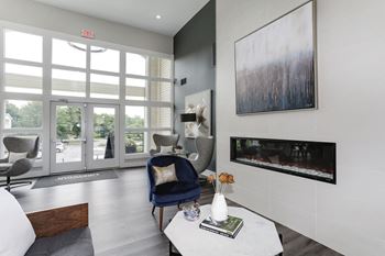 A living room with a blue chair and a white coffee table