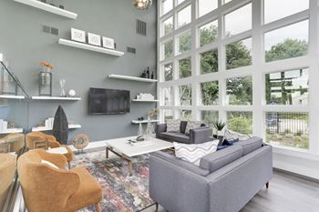 A living room with a large wall of windows