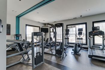 A gym with cardio equipment and weights