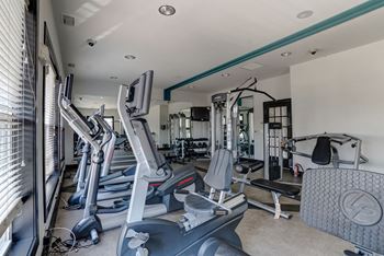 A gym with treadmills and other exercise equipment
