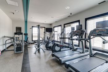 A gym with treadmills and other exercise equipment