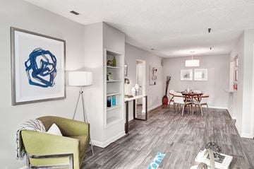 Columbia apartment for rent - a living room with a couch and chair and a dining room table in the background