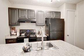 Columbia apartment for rent - a kitchen with gray cabinets and white countertops at Hamilton at Kings Place, Columbia, MD 21046