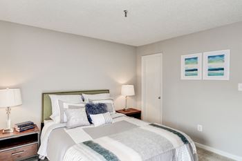 A bedroom with a bed and two night stands