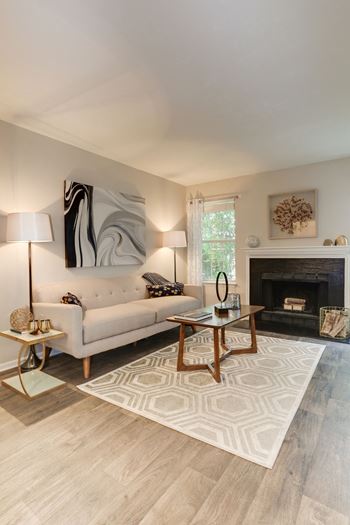 A living room with a couch coffee table and fireplace