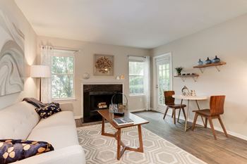 A living room with a couch table and chairs and a fireplace