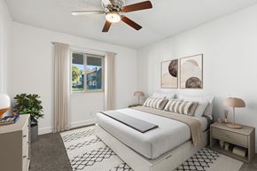 Chandler apartment for rent - A bedroom with a large bed, a ceiling fan, and a window with curtains at Riviera Park, Chandler Arizona