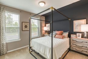 Elkridge apartment for rent - a bedroom with a large bed and two windows