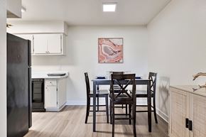 Chandler apartment for rent - A kitchen with a table and chairs and a fridge.at Riviera Park, Chandler, AZ 85224