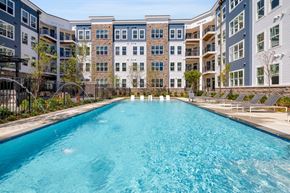 Elkridge apartment for rent - a swimming pool with an apartment building in the background